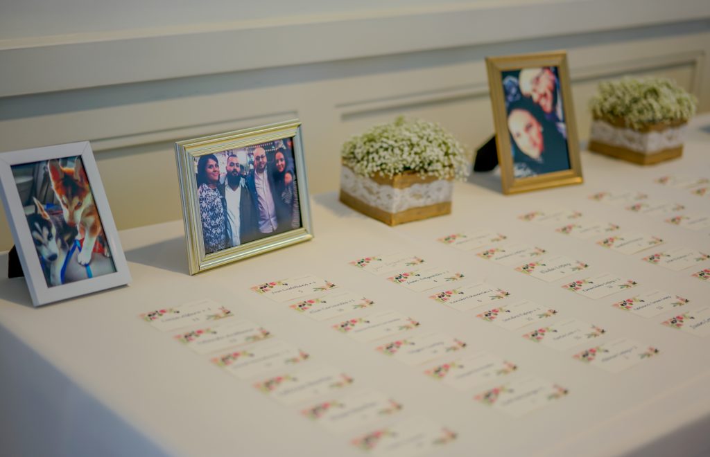 Simple escort cards table with fun candid photos of bride and groom