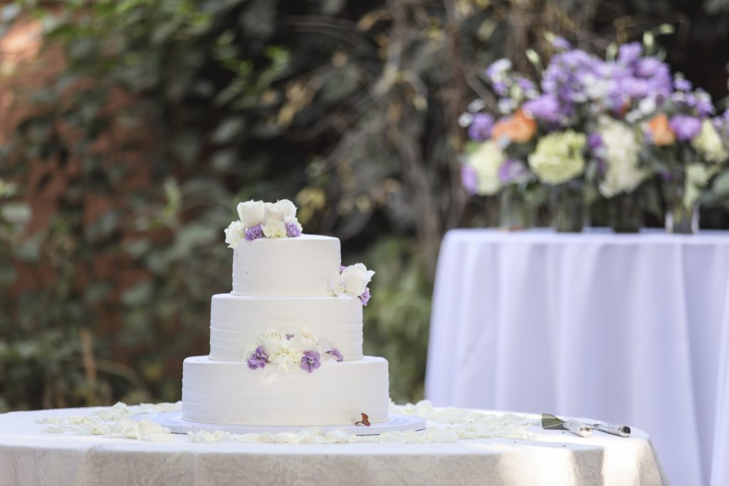 simple buttercream wedding cake with lavender flowers 