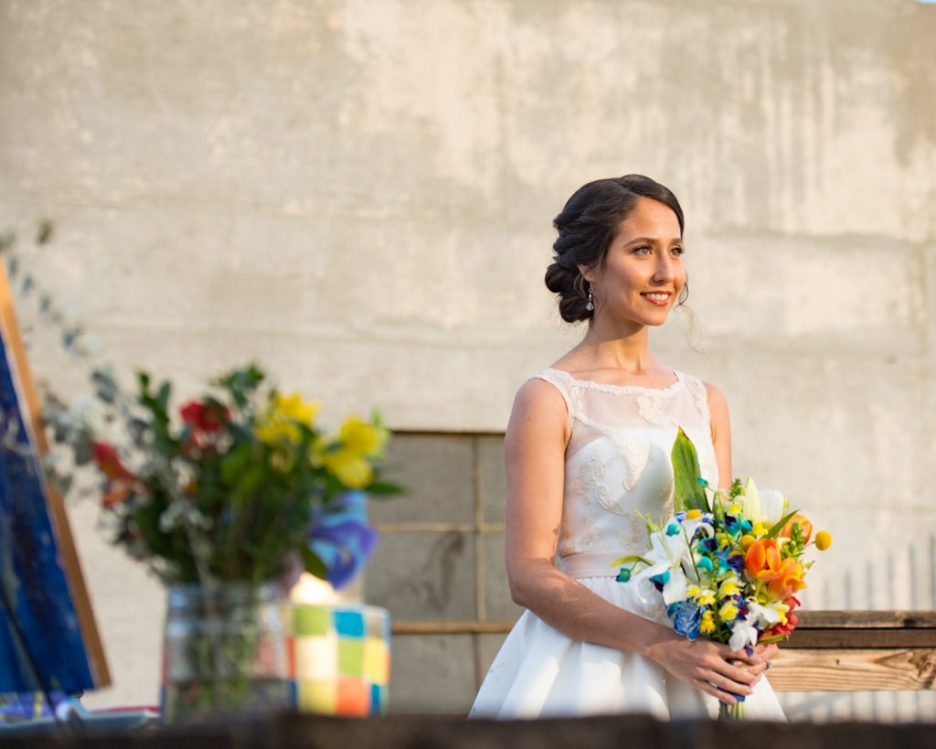Radiant Bride with custom tea length dress and colorful bridal bouquet