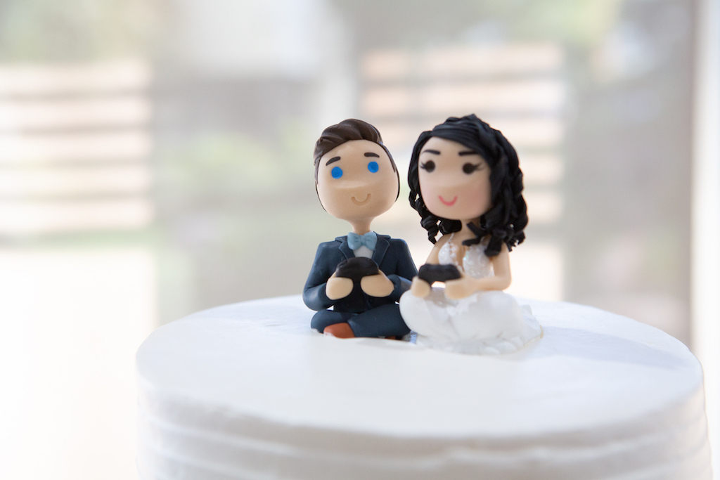 Debra and Claude's custom cake toppers, made to look like them as they played games together, one of their favorite things to do!

Edwin So Photography