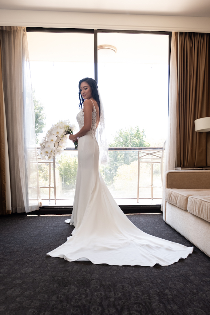 Debra in her beautiful wedding gown with her gorgeous cascading orchid bouquet.

Edwin So Photography
