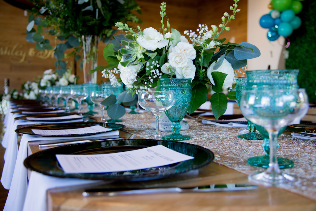 We used black charger plates and accented with turquoise carousel glasses for a pop of color.

Trista Maja Photography