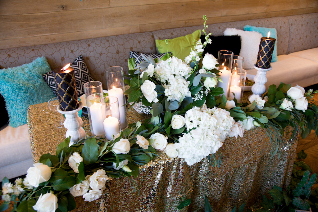 A beautiful sweetheart table set up, with lounging pillows and plenty of candles for ambiance.

Trista Maja Photography