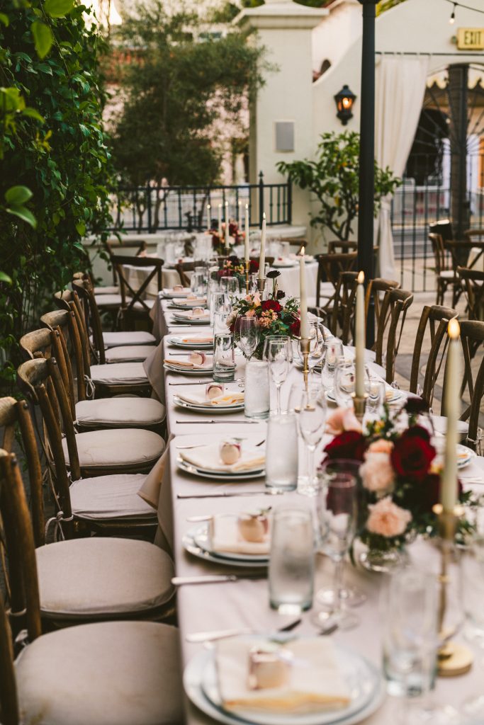 How romantic was this outdoor reception, with flickering tapered candles and gorgeous compote floral arrangements.